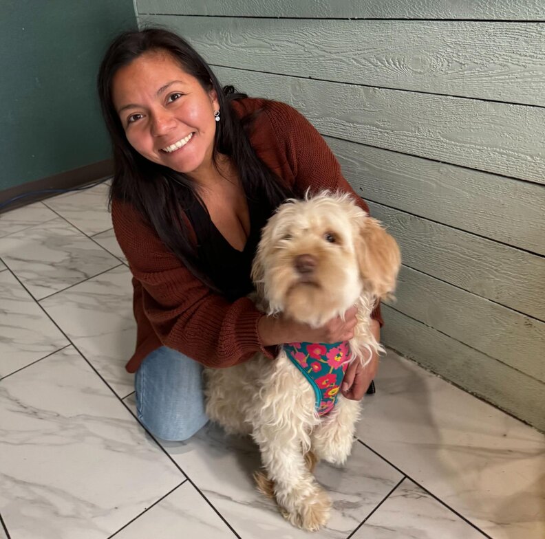 Dog rescuer poses with her pup Bella
