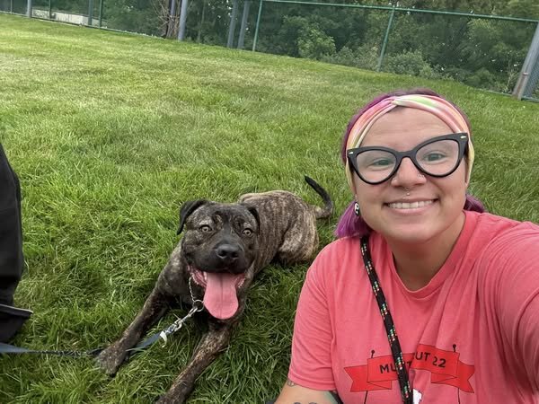 woman and dog in the grass 