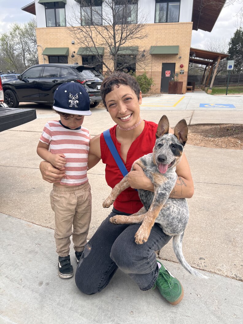 mom and little boy holding a puppy
