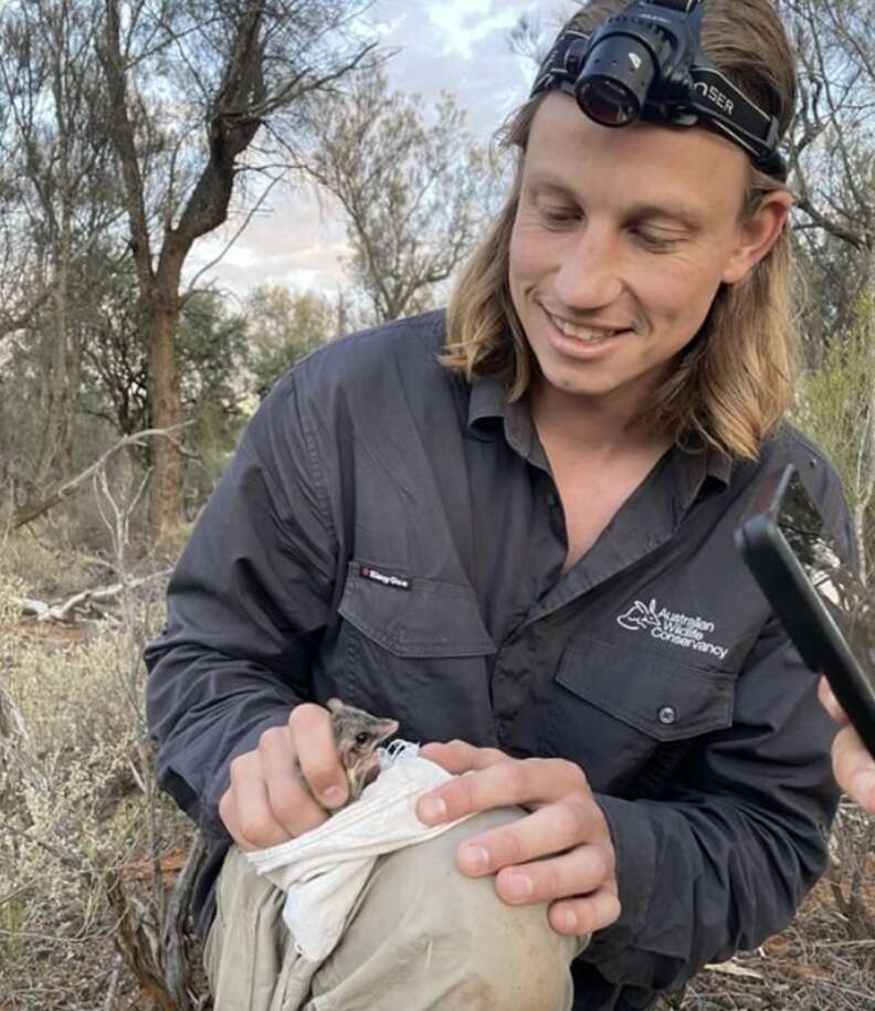man holding rare animal in towel