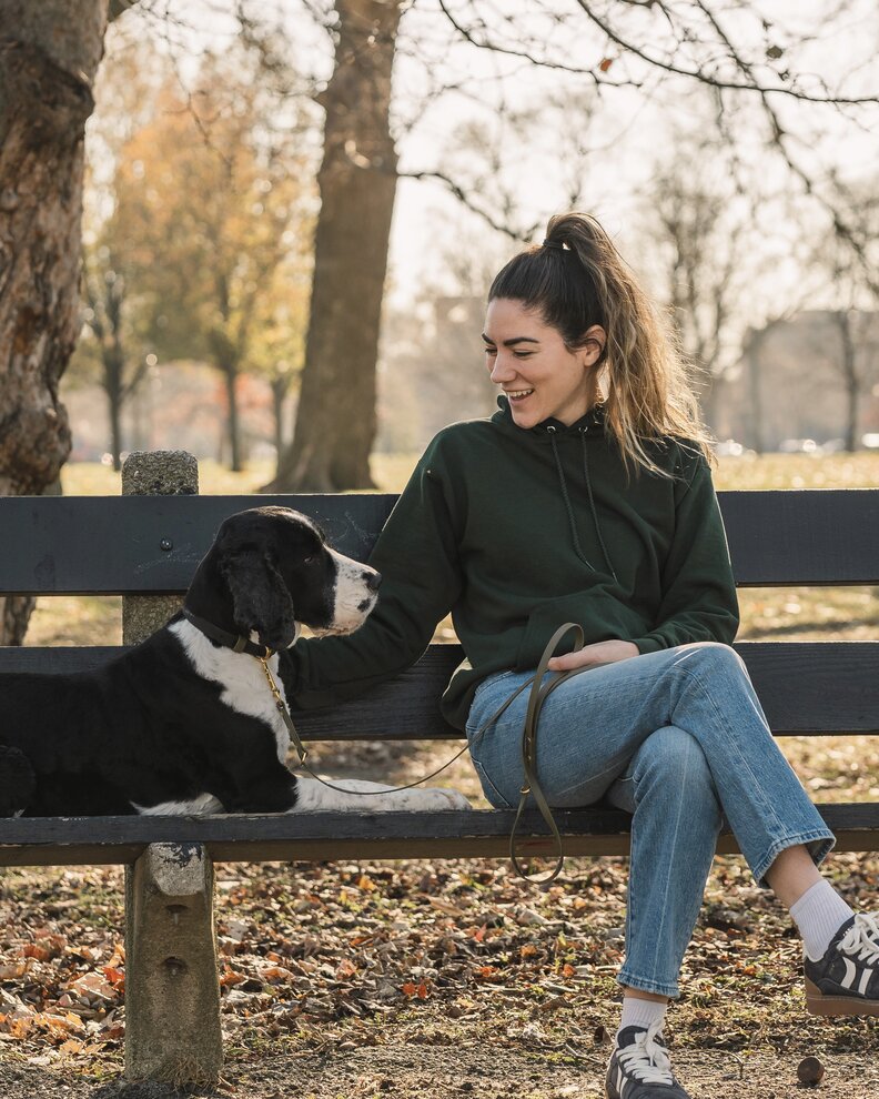 dog and mom on a park bench