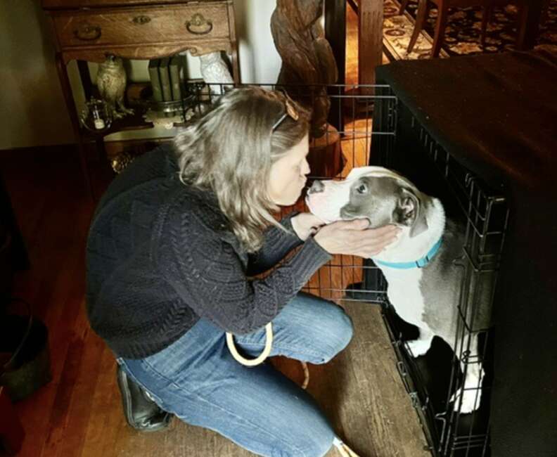woman kissing dog
