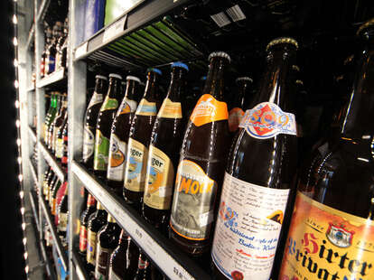 A shelf filled with craft beer bottles.