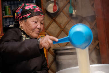 Mongolian woman making cheese