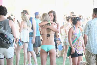 Two girls in the audience hug at Coachella 2013