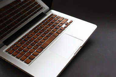 MacBook keyboard covered with wooden skins