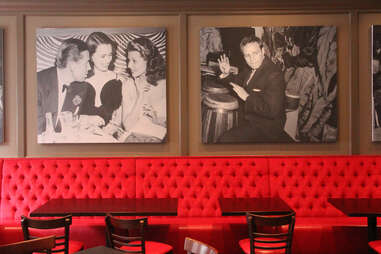 The upstairs red banquettes at Pennsylvania 6 lined with 1940s celebrity photos