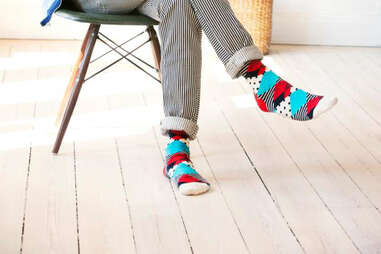 Guy sitting in colorfully striped socks