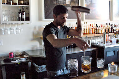 Bartender at Rye on Market mixing two drinks at once.