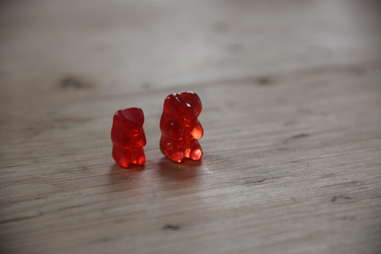 A regular gummy bear next to a vodka gummy bear