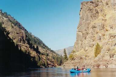 raft on river between two cliffs