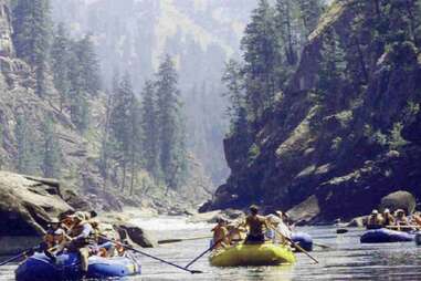 a couple full rafts paddling down river