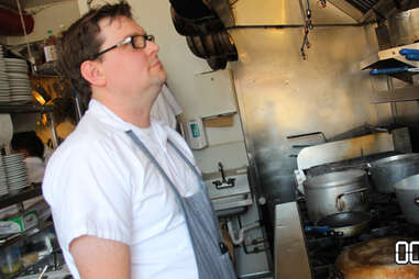 chef looking bored while making mussels dish