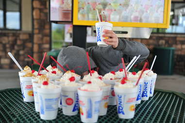 guy eats a peanut butter banana shake at Sonic