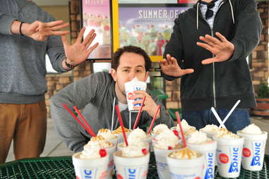 guy eats a peanut butter shake at Sonic