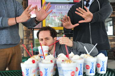 guy eats a cheesecake shake at Sonic