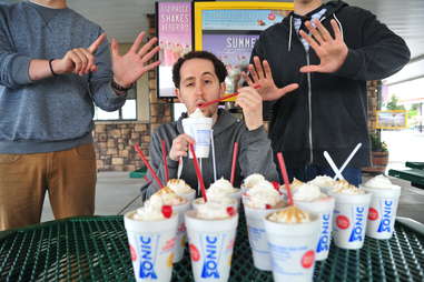 guy eats a chocolate covered strawberry shake at Sonic