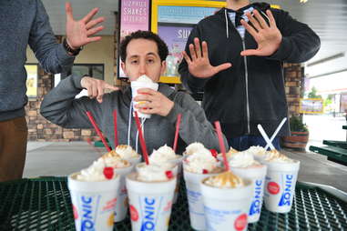 guy eats a vanilla shake at Sonic