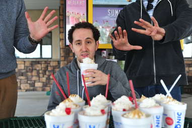 guy eats a peanut butter fudge shake at Sonic