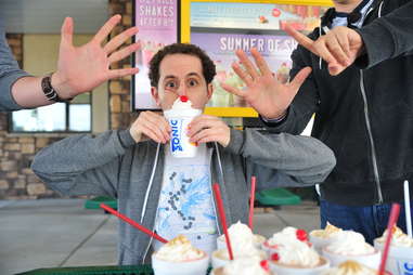 guy eats a caramel milkshake at Sonic