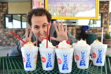 guy eats a hot fudge milkshake at Sonic