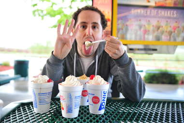 guy eats a peanut butter cookie milkshake at Sonic