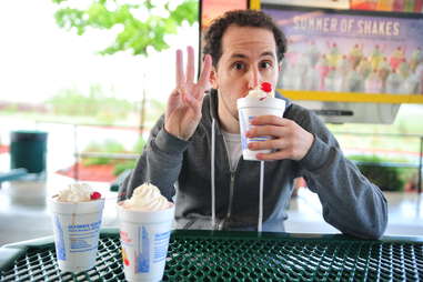 guy eats a cherry milkshake at Sonic