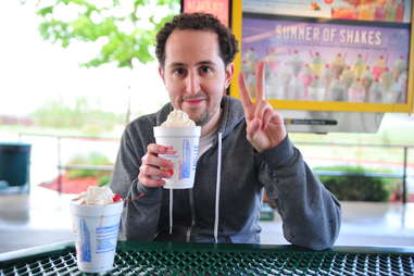 guy eats a chocolate milkshake at Sonic