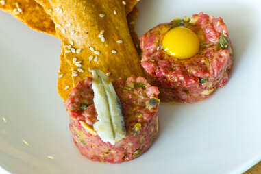 Saltyard - classic German steak tartare w/ quail egg and white anchovy