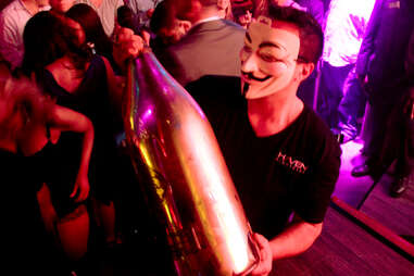 A masked server carries a 15 liter Nebuchadnezzar of Ace of Spades champagne at Haven nightclub at the Golden Nugget in Atlantic City