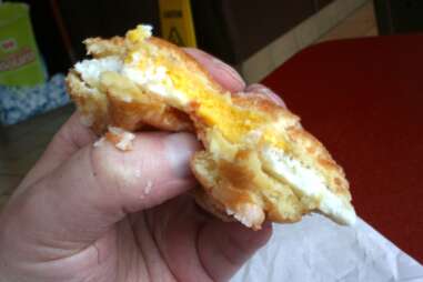 An almost-gone dunkin donuts breakfast sandwich