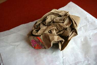 A crumpled Dunkin Donuts bag