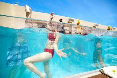 A girl dances in the bungalow plunge pool at HQ Beach Club at Revel