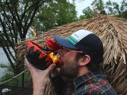 Thrillist Minneapolis Editor Drew Wood drinking from a lava bowl