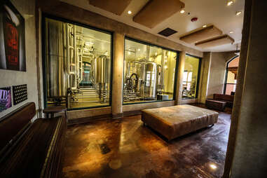 Waiting area with a view of the brewery at Stone Brewing World Bistro & Gardens - Liberty Station in San Diego.