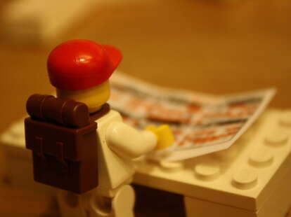 lego person reading paper