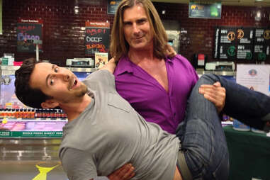 Fabio holding a man in a Whole Foods