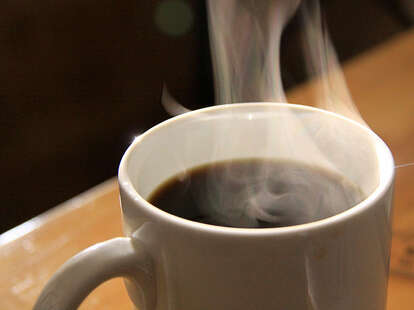 A steaming cup of coffee.