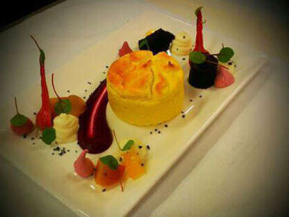 A colorful dish of puff pastry and various jellies on a white plate.