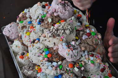 sprinkles going on a sundae at Sweet Cow Ice Cream