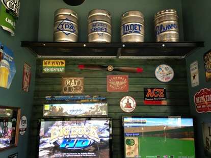 A wall of games and kegs at Addison Ice House