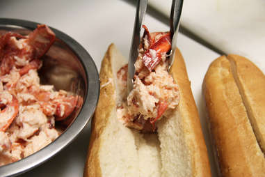 Piling lobster on the USS Lobstitution lobster roll at Pauli's North End
