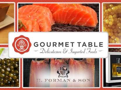 An image of various products you can buy at Gourmet Table, like cheese, caviar, and salmon.