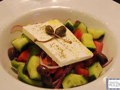 Greek salad with cucumbers, tomatoes, olives, onions, and feta cheese