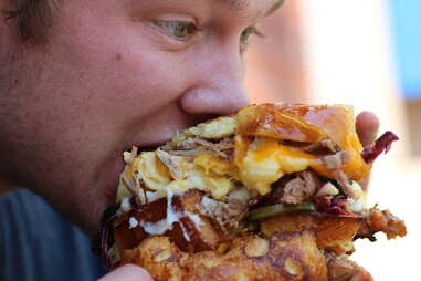 a guy eating a sandwich at Whole Foods