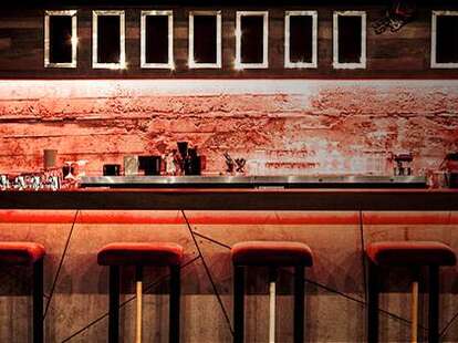 The bar at Joverse lit with orange and red light.