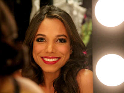 Royal Jelly dancer Alejandra smiles in the mirror backstage.