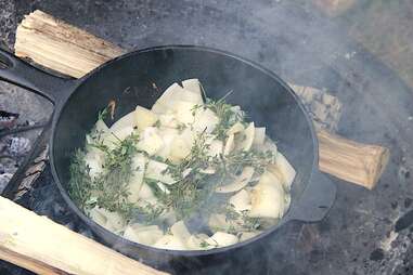 onions and thyme cooking in cast-iron pan