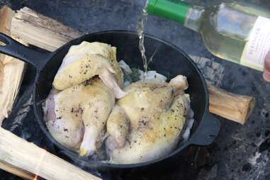 chicken, onions and thyme cooking in cast-iron pan