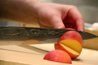 Slicing a peach in the kitchen at The Lambs Club
